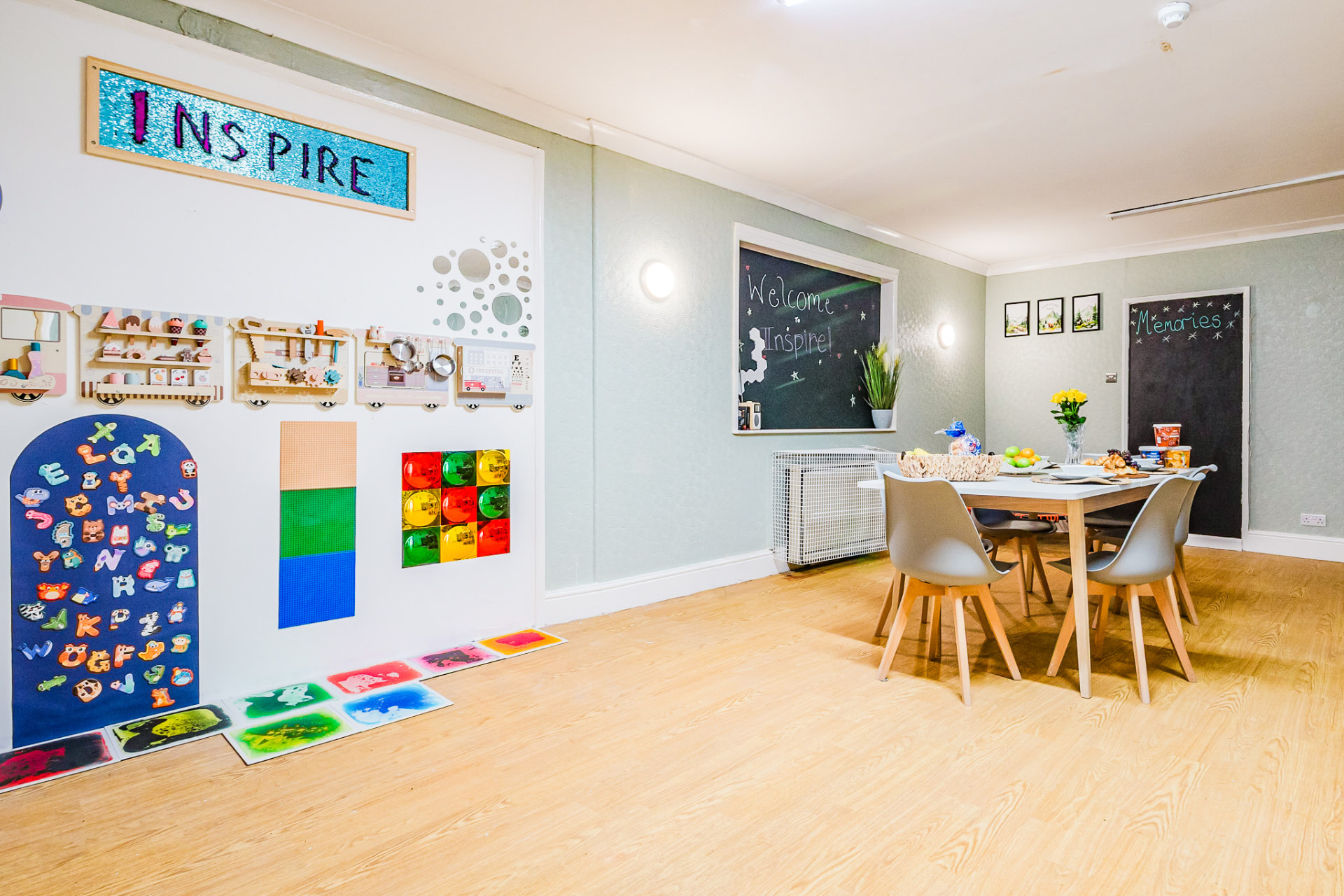 Dining and play area with Inspire wall display at Inspire School