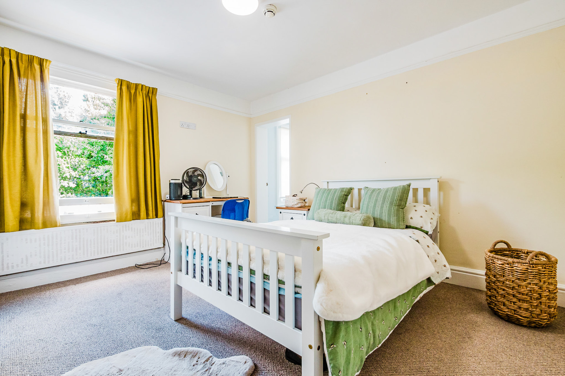 Calm cream bedroom with garden views