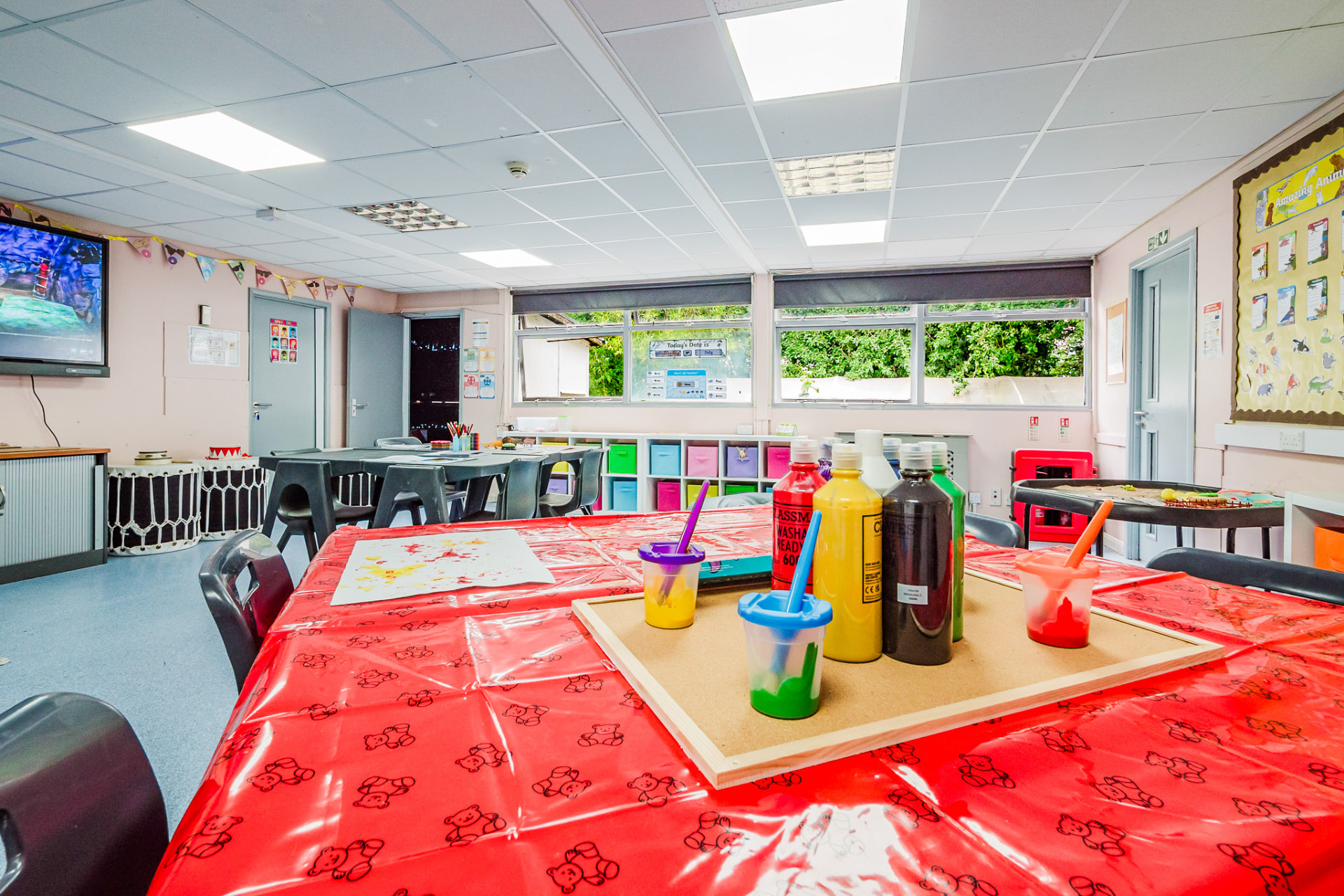 Classroom art table set up with paints and brushes