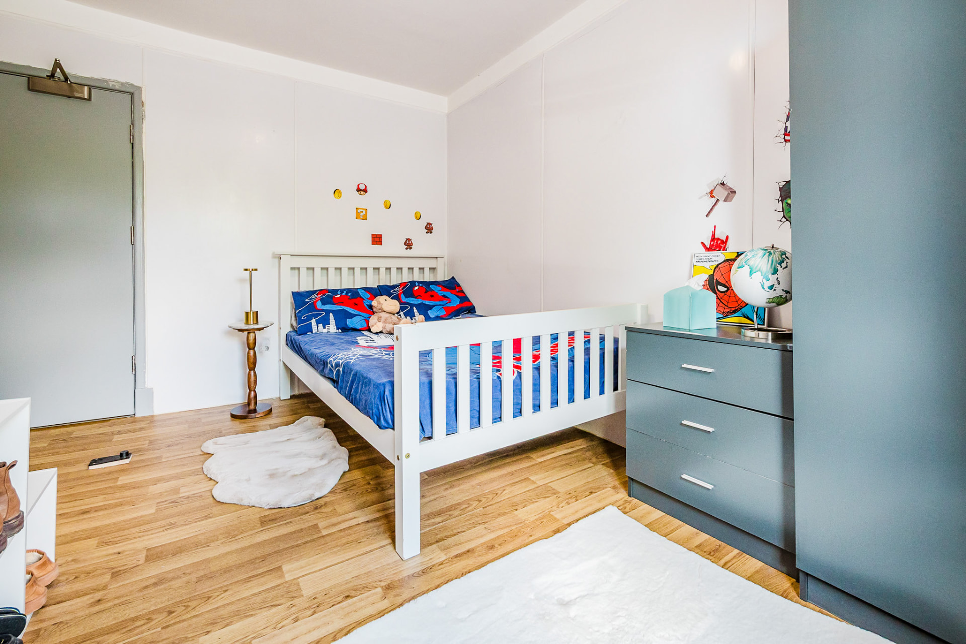 Superhero-themed bedroom with bright bedding
