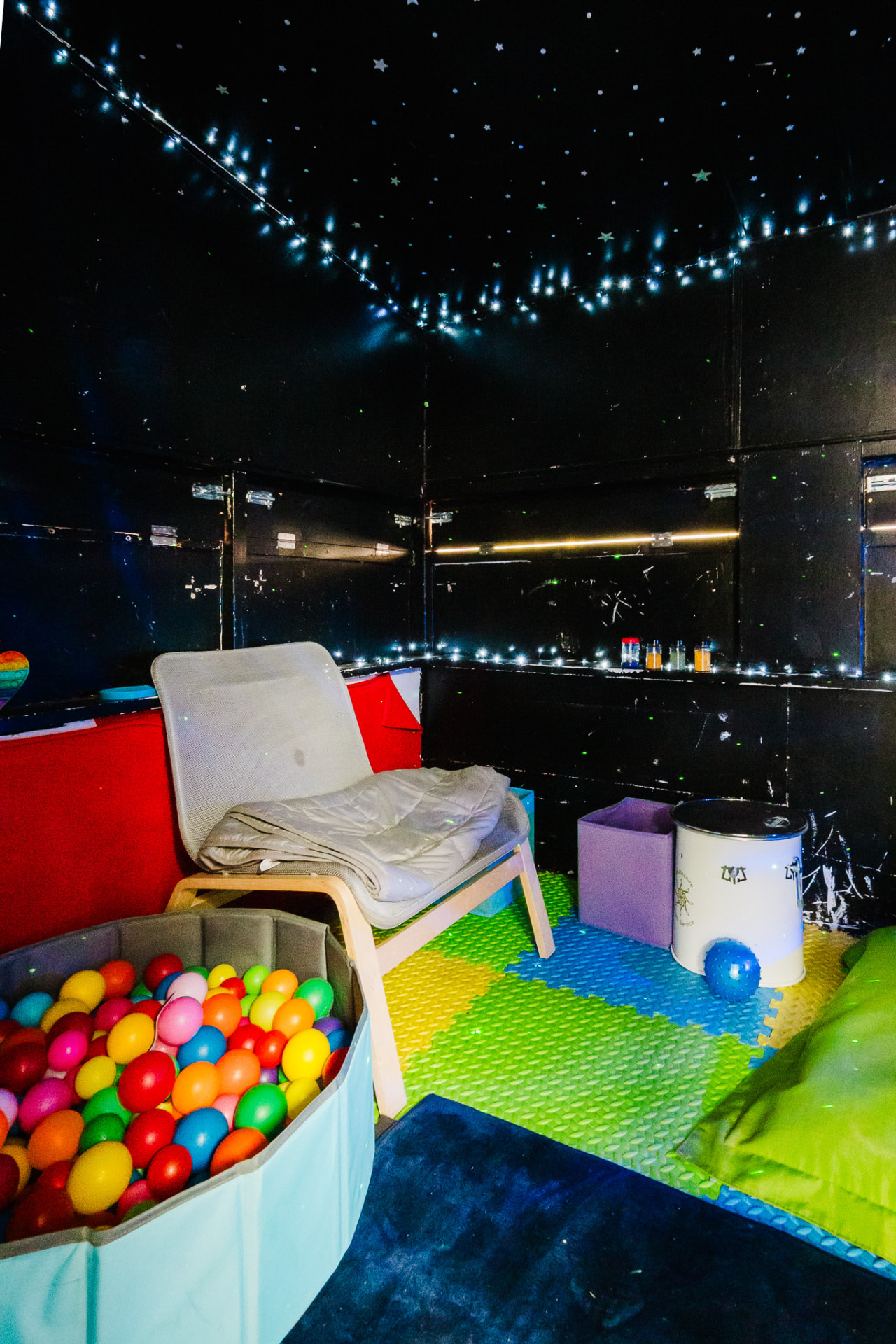 Sensory room with ball pool and bean bags under star lights