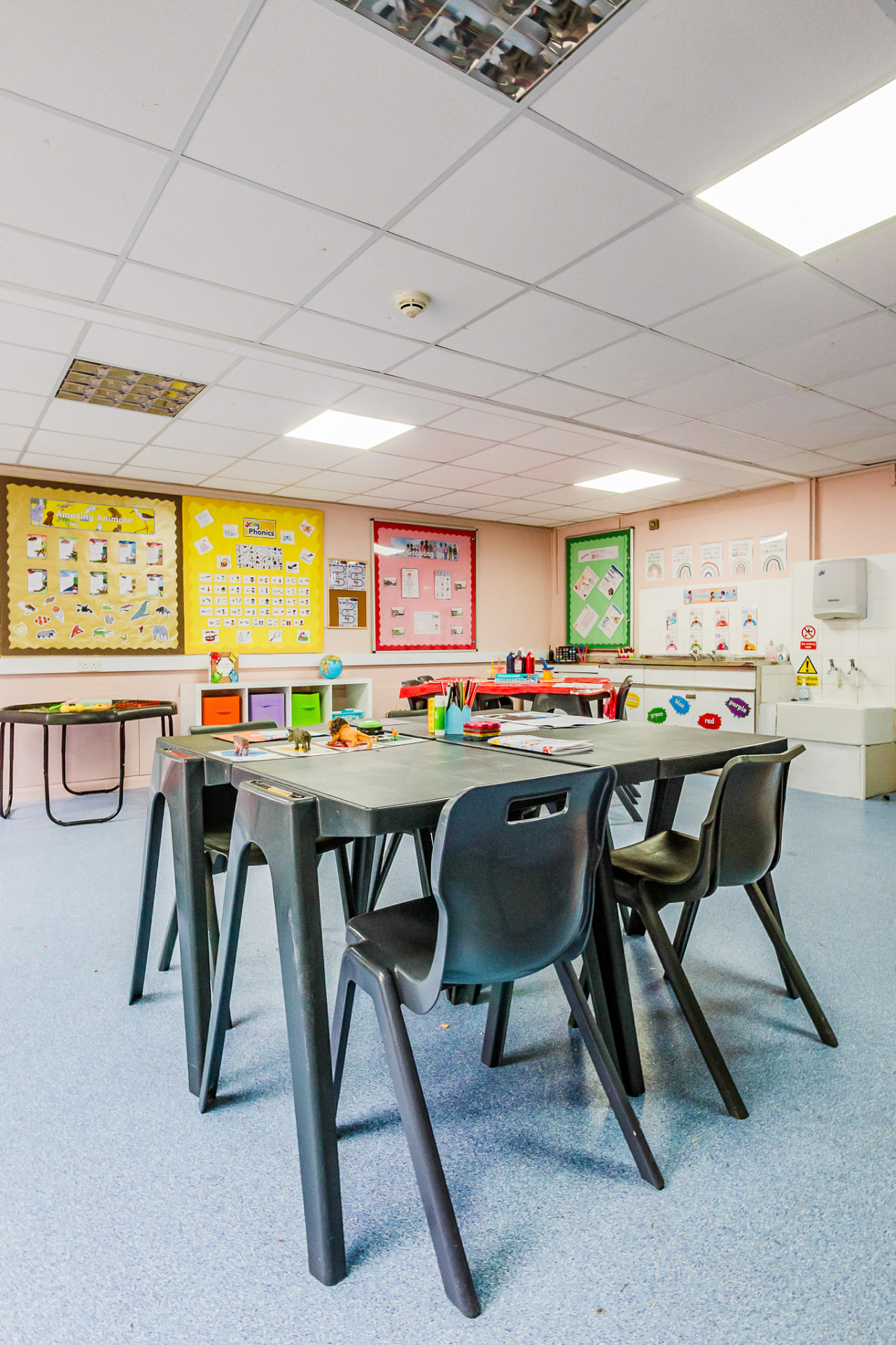 Classroom with group tables and colourful learning displays