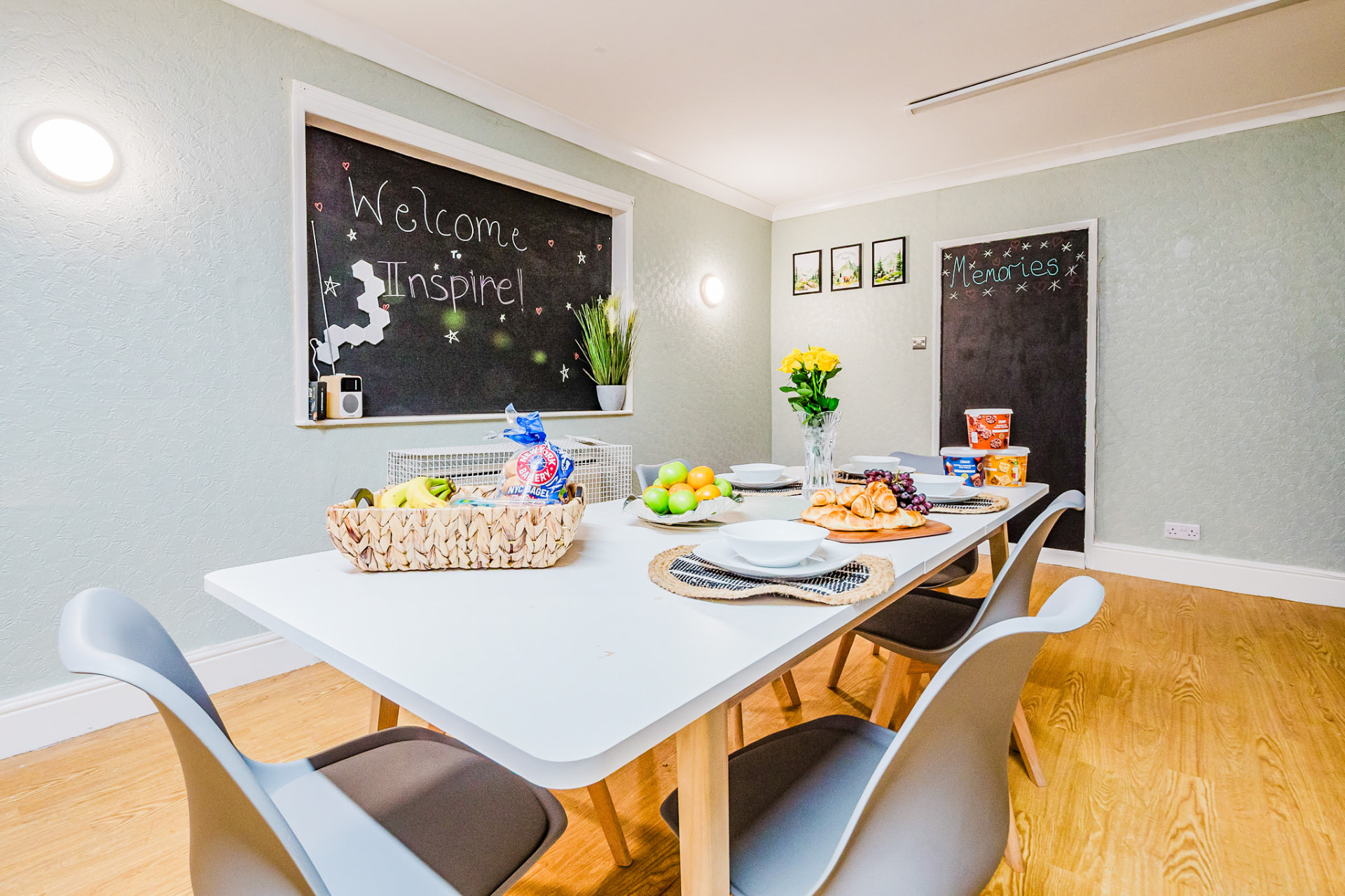 Dining area with a Welcome to Inspire chalkboard