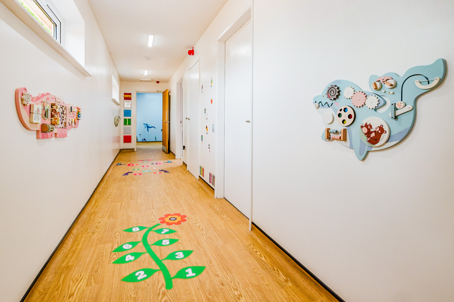 Corridor with sensory wall panels and floor games