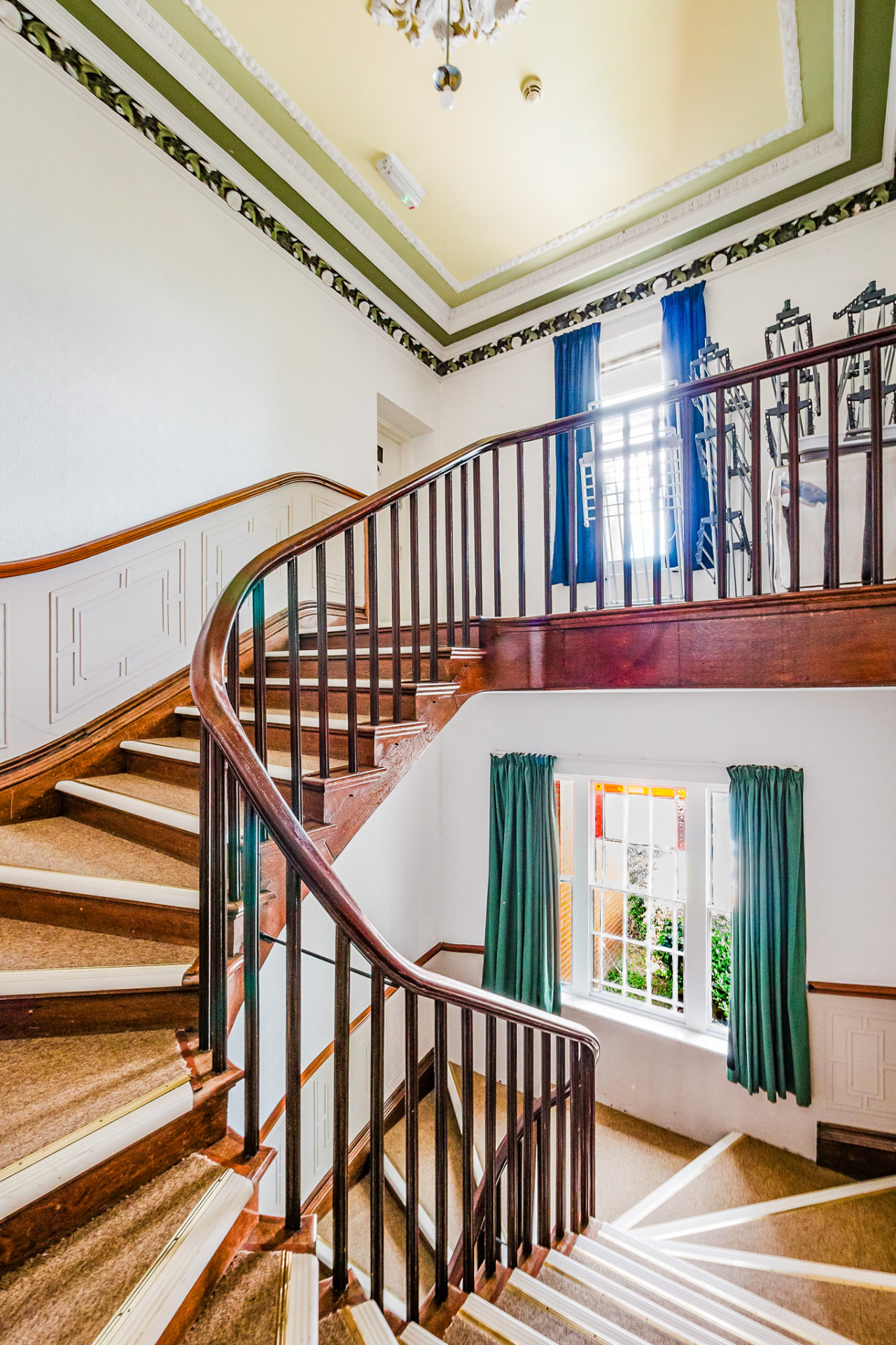 Sweeping period staircase with stained glass window