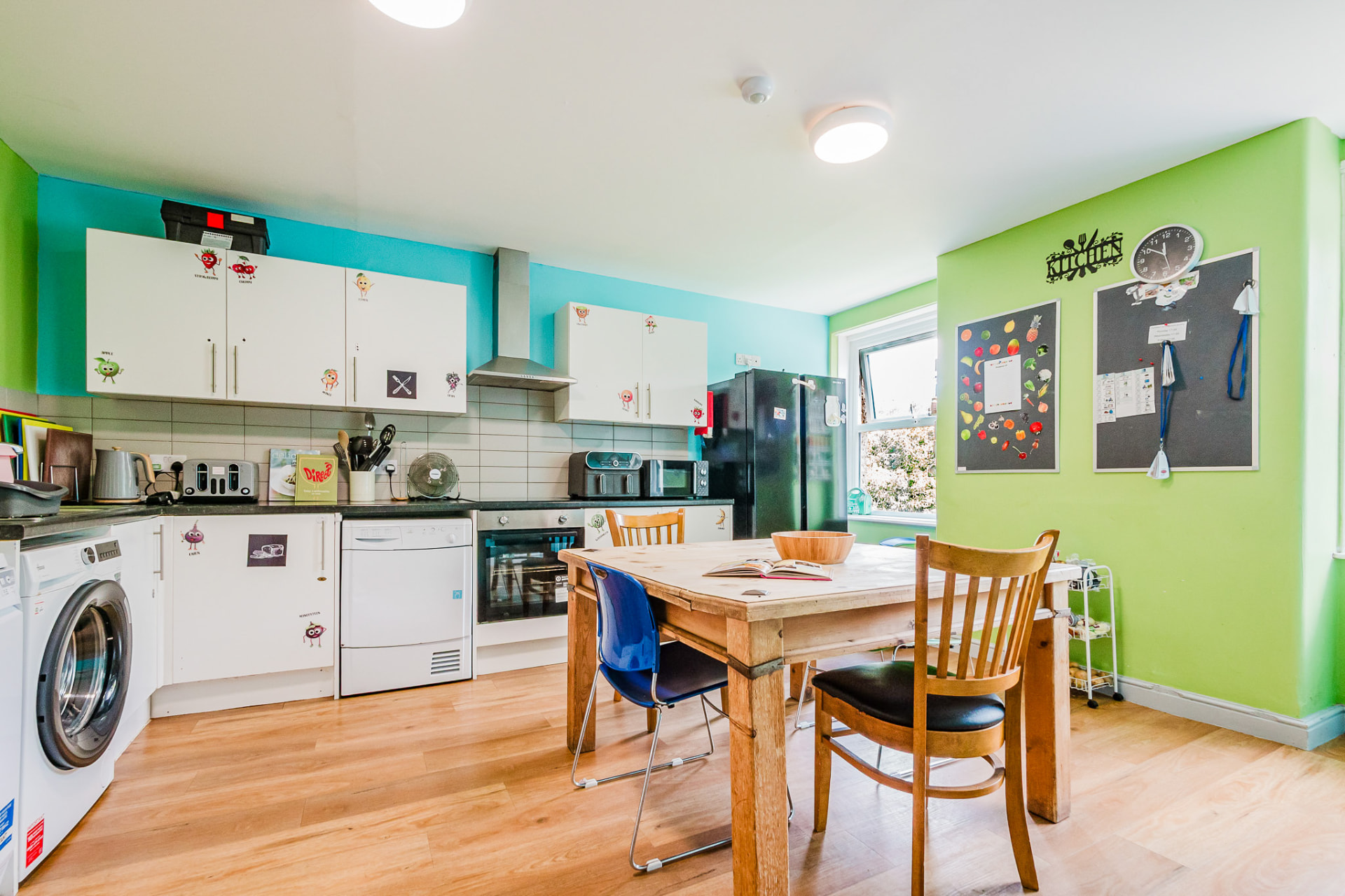 Bright kitchen and dining area with colourful walls