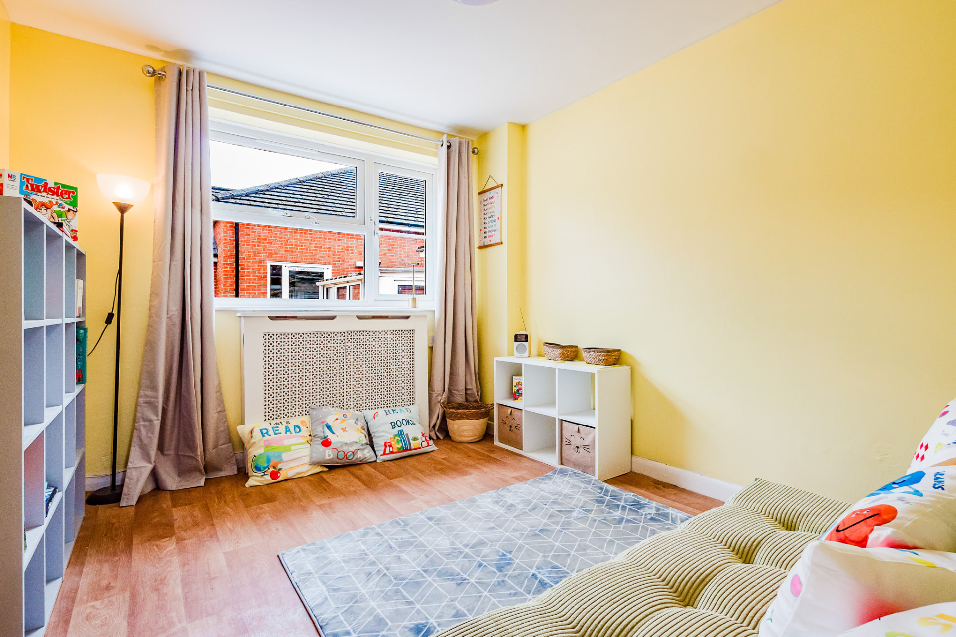 Bright yellow reading room with cushions and books