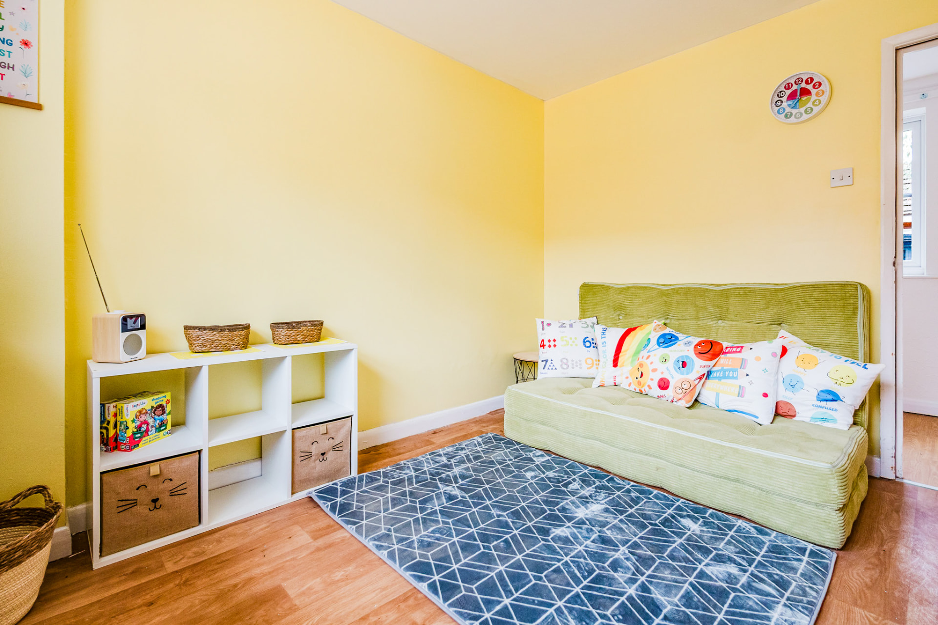 Relaxation room with soft green sofa and games