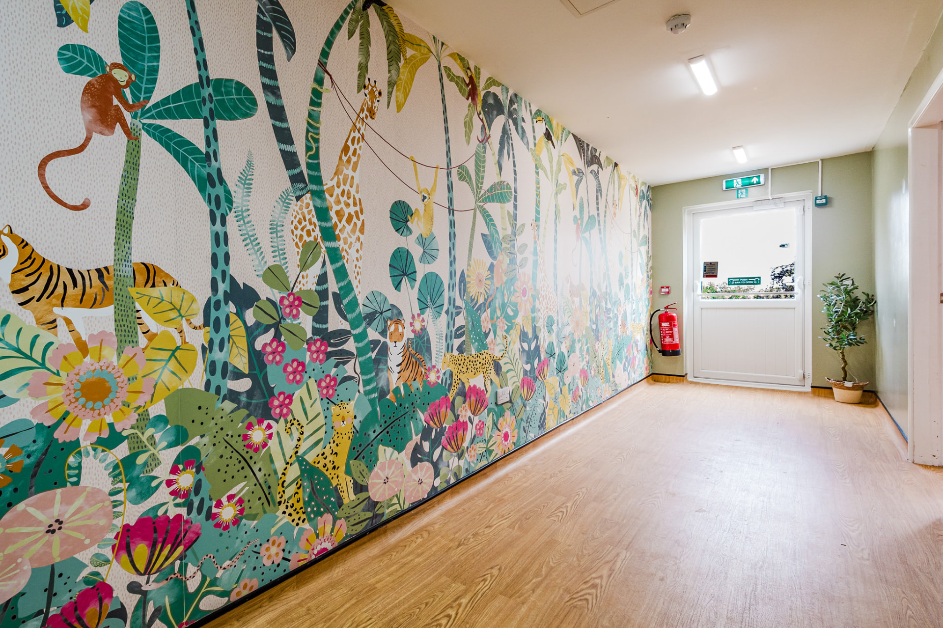 Colourful jungle mural along the corridor wall