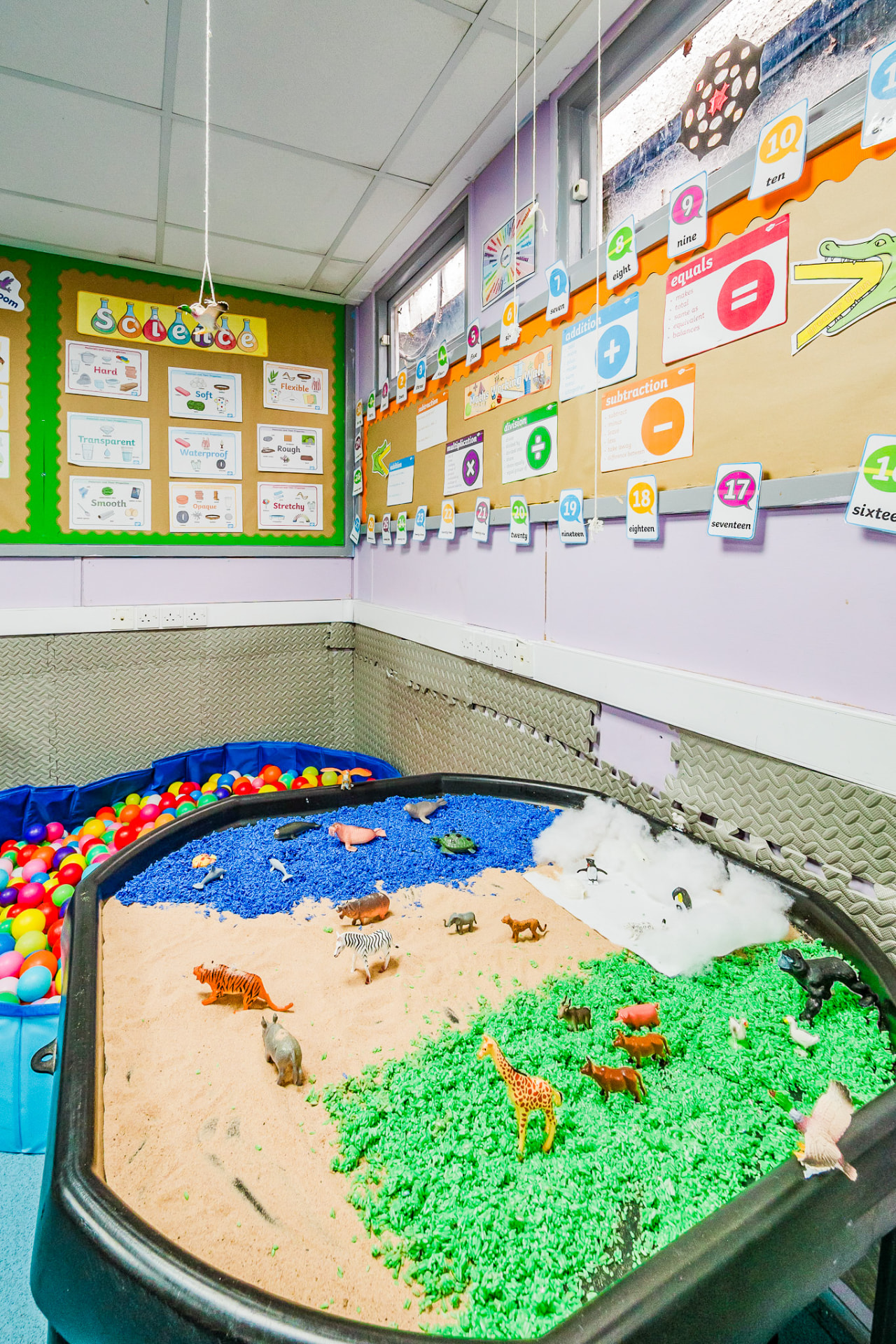 Sensory tray with animals, sand and coloured rice
