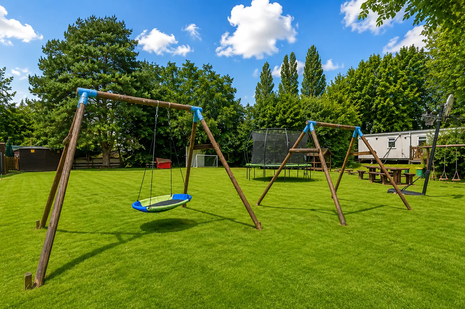 Nest swing and outdoor play equipment on the field